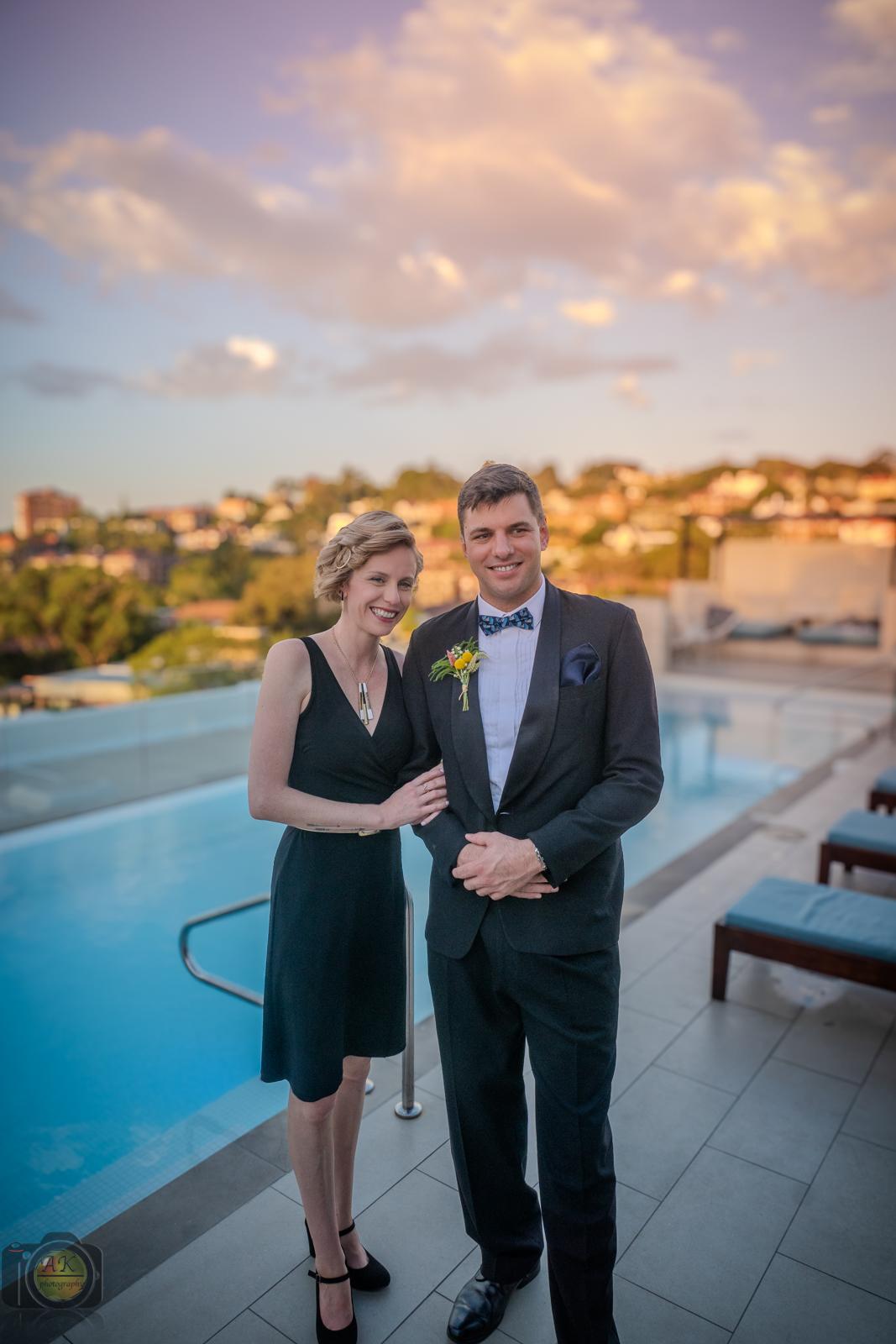 a couple posing for photos for their friends wedding